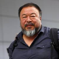 Dissident Chinese artist Ai Weiwei leaves the airport in Munich on July 30. Ai Weiwei said that Britain had denied his application for a six-month visa in favor of one with a shorter duration, telling him that he had not declared a previous criminal conviction. Artist Ai Weiwei says he has new 'basis of trust' with China authorities