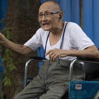 World War II veteran Saw Berny, who is ethnic Karen, talks during an interview Wednesday with the Associated Press, in Yangon. Seventy years after World War II ended, withered and mostly impoverished veterans will gather at the graveside of a British officer who almost no one in England remembers. Maj. Hugh Paul Seagrim, or Grandfather Longlegs, who remains a legend up in the hills of Myanmar, among a beleaguered ethnic minority for whom peace never came. Karen honor Japanese-executed British officer 'Longlegs' for bravery in wartime Burma