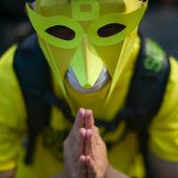 A protester offers prayers Sunday, the second day of a demonstration being held in Kuala Lumpur demanding Prime Minister Najib Razak’s resignation and electoral reforms. Tens of thousands of Malaysians swarmed central Kuala Lumpur a day earlier to call for Najib’s ouster over corruption allegations and broader reforms, defying warnings by police who had declared the rally illegal. Malaysia protests persist as Najib government threatens retaliation