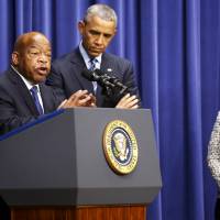U.S. Rep. John Lewis, a Georgia Democrat, introduces President Barack Obama to speak at a Thursday conference to commemorate the 50th anniversary of the Voting Rights Act at the White House as U.S. Attorney General Loretta Lynch looks on. Obama again calls for restoration of Voting Rights Act in face of Republican opposition