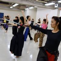 Women dressed in hakama practice katana sword exercise at a studio in Tokyo's Meguro Ward on Aug. 3. Katana swordplay exercise is a hit with Tokyo women
