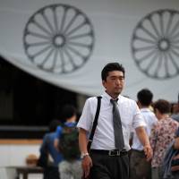 Hidetoshi Tojo, the great-grandson of Hideki Tojo, who was prime minister during much of World War II, walks away after offering a prayer at Yasukuni Shrine in Tokyo on Thursday. War leaders' scions want reconciliation