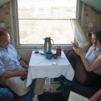 Shared space: Jeremy Hainsworth (left) and Shelagh Travers pass time aboard the Trans Mongolian Express as it crosses Mongolia’s Gobi Desert. Taking one of the world's longest train rides