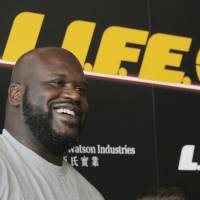 Former NBA star Shaquille O'Neal poses for photographers during a news conference to launch an energy drink in Hong Kong on Tuesday. Shaq insists a young MJ would beat LeBron one-on-one