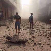 People look on after explosions hit Liucheng county, Guangxi Zhuang Autonomous Region, China, on September 30, 2015. 'Dozens' of injuries, six dead after multiple explosions hit public buildings in southern China