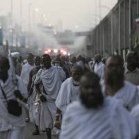 Pilgrims walk by the site where pilgrims were crushed and trampled to death during the annual hajj pilgrimage in Mina, Saudi Arabia, Thursday. The crush killed hundreds of pilgrims and injured hundreds more in Mina, a large valley on the outskirts of the holy city of Mecca, the deadliest tragedy to strike the pilgrimage in more than two decades. Iran has blamed the Saudis for the disaster. Saudis to blame for deadly hajj crush that killed at least 717, Iran's supreme leader charges