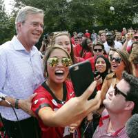 Republican presidential candidate and former Florida Gov. Jeb Bush poses during a tailgate party before an NCAA football game Saturday in Athens, Georgia. Hewing toward Republican rivals, Bush says multiculturalism wrong for U.S.