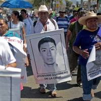 A relative of Mexican missing student Jhosivani Guerrero de la Cruz holds his portrait during a march in Acapulco, Guerrero State, Mexico, on March 4. Jhosivani Guerrero is the second of the 43 missing students of Ayotzinapa whose remains are identified, the Mexican government informed on Wednesday. Mexican authorities announced the arrest Thursday of a prime suspect in the massacre, but relatives doubt the truth will come out. Alleged mastermind behind massacre of 43 Mexicans nabbed but mystery continues