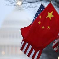 The People's Republic of China flag and the U.S. Stars and Stripes fly along Pennsylvania Avenue near the U.S. Capitol in Washington during Chinese President Hu Jintao's state visit in this January 2011 file photo. The White House is considering applying sanctions against companies and individuals in China it believes have benefited from Chinese hacking of U.S. trade secrets, the Washington Post reported on Sunday. U.S. eyes sanctions against China cyberattacks that hurt firms, expose spies