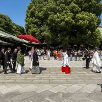 The big day: A wedding procession marches through a shrine, a more public affair than the nuptials of many celebrities. Working the politics of an idol marriage
