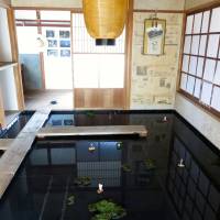 Above: Tomoko Tano, executive director of the Heart Art Link NPO, which organized the Art Bridge Project on Shiraishi Island, stands in front of a work by Kotaro Nagira. Right: Naoto Shimizu recreated the Seto Inland Sea in the floor of a traditional house. Can art bring people back to Japan's depopulated islands?