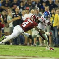 Mississippi wide receiver Demarcus Lodge pushes away Alabama defensive back Eddie Jackson in Tuscaloosa, Alabama, on Saturday. The Rebels beat the Crimson Tide 43-37 Ole Miss rallies past rival Alabama