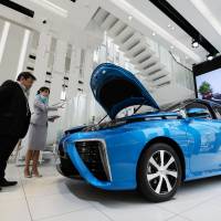 A Toyota Motor Corp. Mirai fuel cell-powered vehicle sits on display at the company's showroom in Tokyo. The construction of hydrogen refueling stations is behind schedule around the world. Futuristic hydrogen cars come with a curfew — for now