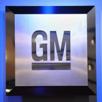 The General Motors logo is seen in 2009 at the North American International Auto Show in Detroit. GM issued a recall Tuesday for 1.4 million older cars in North America over the risk that they could catch fire from leaking oil. Oil leaks, including on cars previously fixed, prompt GM to recall 1.4 million vehicles