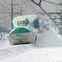 A picture taken in December 2014 shows a Hokkaido Shinkansen train on a test run in Hokuto, Hokkaido. Tokyo-Hokkaido bullet-train fees to be cheaper than airfares