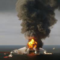 Fire boat response crews battle the blazing remnants of the BP-operated Deepwater Horizon offshore oil rig in the Gulf of Mexico in April 2010. U.S., five states announce settlement with BP over gulf oil spill
