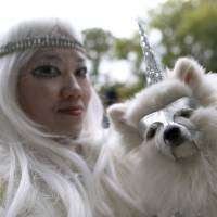 Chong Cha, wearing a wizard costume, and her Pomeranian Zuzu, dressed as a unicorn, participate in the Tompkins Square Halloween Dog Parade in New York on Saturday. New York park goes to the dogs for Halloween parade
