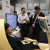 Visitors to an August trade show in Koto Ward, Tokyo, try out a computer-controlled Smartchair prototype jointly developed by Nagoya University and Panasonic Corp. Nagoya University leads way in developing next-generation products