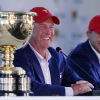U.S. team captain Jay Haas (left) and his son Bill address a news conference after the Americans retained the Presidents Cup by defeating the International team 15 1/2 to 14 1/2 on Sunday in Incheon, South Korea. U.S. seals Presidents Cup victory