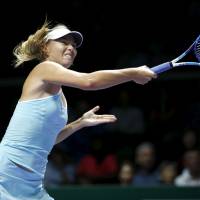 Maria Sharapova hits a shot during her match against Simona Halep at the WTA Finals in Singapore on Tuesday. Sharapova gets second straight win