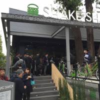 Eager customers form a line in front of New York-based hamburger restaurant chain Shake Shack before it opened its first Japanese outlet in Tokyo’s Meiji Jingu Gaien park on Friday. First Shake Shack in Asia opens to long lines in Tokyo