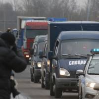 Journalists film as trucks carry the bodies of the Metrojet Airbus crash victims from a city morgue to the crematorium for identification in St.Petersburg, Russia, Monday. The Airbus A321-200 crashed in the Sinai Peninsula on Saturday morning 23 minutes after taking off from Sharm el-Sheikh en route to St. Petersburg. All 224 people on board were killed, the vast majority of them Russians, who are being repatriated. Aeroflot spinoff Metrojet had spotty record, rebranded after fatal fire aboard taxiing Tu-154
