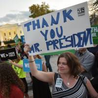 Activists celebrate U.S. President Barack Obama's blocking of the Keystone XL oil pipeline outside the White House on Friday. Obama rejects Keystone pipeline, strengthening his hand at global climate talks