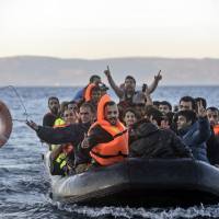 Migrants and refugees arrive on the shore of the Greek island of Lesbos after crossing the Aegean Sea from Turkey on Thursday. European Union and African leaders approved a €1.8-billion action plan they hope will help stem an unprecedented and politically explosive flow of migrants across the Mediterranean. Amid 'fortress Europe' fears, EU offers Africa aid, Turkey talks to mitigate migrant crisis