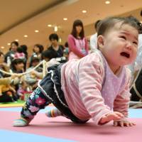 Going for goldA baby takes part in a crawling competition Monday in Yokohama hosted by a magazine that specializes in pregnancy, childbirth and child-rearing. The organizers were trying to win recognition by Guinness World Records for the biggest crawling competition ever. Babies crawl and bawl to finish line in Japan race