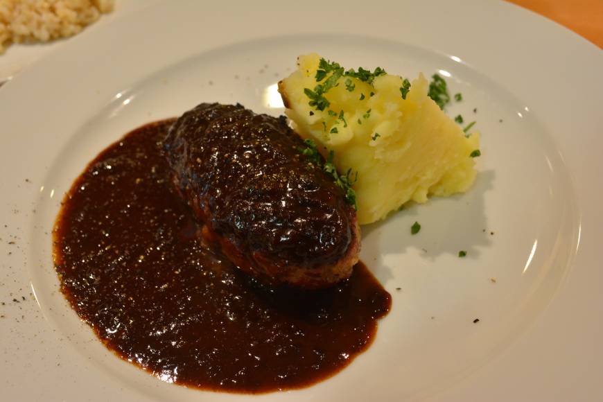 Sept Bistro Succulent hamburger hidden under a rich red wine sauce | J.J. O'DONOGHUE