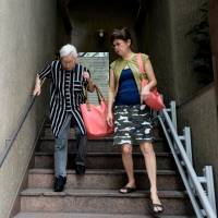 Dealing with dementia: Akiko Sakai (right) walks with her mother, Asayo, a former nurse and housewife who has been diagnosed with Alzheimer’s disease. Japan's children face a dementia boom