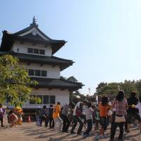 Locals and visitors take part in the centenary relocation of Hirosaki Castle by tugging on ropes attached to the building. Aomori's moving castle and other architectural tales