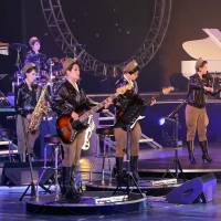 In a picture from April 2014, North Korea's premier pop group, the all-girl Moranbong Band, plays at a show for the country's leader Kim Jong Un. China says visit by popular North Korean band is important