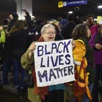 Black Lives Matter protesters chant slogans at the Mall of America light rail station in Bloomington, Minnesota, Wednesday. Demonstrations by Black Lives Matter to protest police killings of black men took place in Minnesota and California on Wednesday, a day the activist group dubbed Black Xmas to show it could impact the economy on one of the busiest shopping days of the year. Black Lives Matter stages Minnesota, California 'Black Xmas' protests in bid to disrupt key shopping day