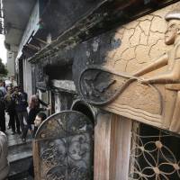 Egyptian investigators check the scene of a nightclub attack in Cairo which killed and wounded over a dozen people, Egypt's state-run news agency reported. MENA quoted an unnamed security official as saying three men on a motorcycle threw Molotov cocktails into the club in the Agouza district and then fled. 16 killed in firebomb attack at Cairo nightclub