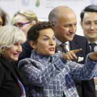 French Foreign Affairs Minister Laurent Fabius (second from right), Christiana Figueres (center), executive secretary of the United Nations’ Framework Convention on Climate Change, and Laurence Tubiana (left), France’s head negotiator, react during the final plenary session at the World Climate Change Conference 2015 (COP21) at Le Bourget, near Paris, on Saturday. After world comes together in a desperate bid, what now for planet's climate?