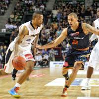 Fukuoka’s Josh Peppers (right), seen defending Yokohama’s Draelon Burns in a 2013 file photo, demonstrates how a committed defender stays close to his man. Defense paying dividends in West