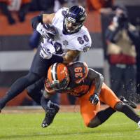 Baltimore's Crockett Gillmore is tackled by Cleveland's Tashaun Gipson on Monday. The Ravens defeated the Browns 33-27. Ravens sink Browns on final play