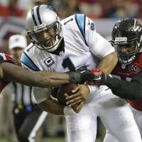 Panthers quarterback Cam Newton is caught between Falcons nose tackle Jonathan Babineaux (left) and linebacker Justin Durant on Sunday in Atlanta. The Falcons beat the previously undefeated Panthers 20-13. Panthers suffer first defeat
