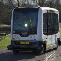 A WEpod driverless bus, developed by WEpods Consortium and Wageningen University, travels on a road in the university's campus site in Wageningen, Netherlands, on Thursday. The WEpod is a fully automated electric powered self-driving vehicle without steering wheel or peddles and is due to start operating on public highways later this year. Dutch test self-drive minibuses, hope to have them operational by midyear