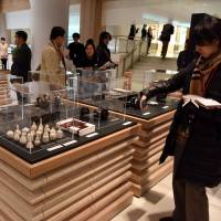Reporters view Japan Duty Free Ginza on Tuesday. The space is a new duty free shop located within the Mitsukoshi department store in Tokyo's upscale Ginza district. Airport-style duty-free shop opens in Tokyo's Ginza