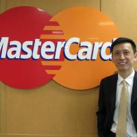 Ling Hai, co-president of MasterCard's Asia-Pacific region, poses for a photo at the firm's Tokyo office this month. MasterCard hopes to catch fintech wave for cashless payments in Asia