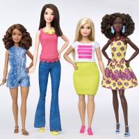 The new Barbie body shapes of petite, tall and curvy are seen next to the traditional Barbie (right). Barbie doll gets three new looks