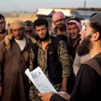 In this file photo released on May 14, 2015, by a militant website, which has been verified and is consistent with other AP reporting, a member of the Islamic State group's vice police known as Hisba reads a verdict handed down by an Islamic court in Raqqa, Syria, sentencing many they accused of adultery to lashing. A Hisba member must be gentle and pleasant toward those he orders or reprimands, says an Islamic State document obtained by AP. Yet, escaped Syrians all complained of the cruelty of the Hisba. Islamic State escapees cite growing disillusion, double standards of mere 'criminal gang'