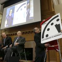 The Bulletin of the Atomic Scientists member Lynn Eden (right) and editor-in-chief John Mecklin (second from right) unveil the Doomsday Clock, which measures the likelihood of a global cataclysm, at Stanford University in Stanford, California, Tuesday. Also pictured (from left) are former U.S. Secretary of State George Shultz, former U.S. Secretary of Defense William Perry, Gov. Jerry Brown and Jerry Seelig. The bulletin announced that the minute hand on the metaphorical clock remained at three minutes-to-midnight. Doomsday Clock stays at 'not good news' 3 minutes till midnight