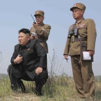 North Korean leader Kim Jong Un watches a rocket launching drill in this undated photo released in April 2014. U.S. faces resistance to slapping North Korea with regime-busting sanctions