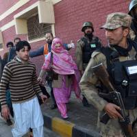 Pakistani soldiers rescue people from Bacha Khan University following an attack by militants in Charsadda, about 50 kilometers from Peshawar, on Jan. 20, 2016. Pakistan Taliban kill at least 19 as they storm university