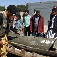 Yemenis gather around the remains of a rocket during a protest in front of the United Nations office calling for an end to the military operations carried out by the Saudi-led coalition on Yemen, in the capital Sanaa, on Sunday. Missile strike hits another Yemen clinic, kills four in what MSF condemns as 'worrying pattern'