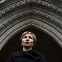 Marina Litvinenko, widow of murdered ex-KGB agent Alexander Litvinenko, reads a statement outside of the Royal Courts of Justice in London on Thursday. President Vladimir Putin probably approved a Russian intelligence operation to murder Litvinenko, a judge led-British inquiry into the 2006 killing in London concluded. Putin probably approved plan to poison ex-spy: U.K. judge