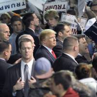 Presidential candidate Donald Trump stands near the crowd to sign autographs and shake hands at a rally held at the Mabee Center in Tulsa, Oklahoma, Wednesday. 'Pro-life' U.S. evangelicals skeptical of Trump's faith as candidate reaches out